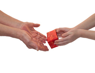 Baby hand giving a gift from the hands of old women. Isolated on