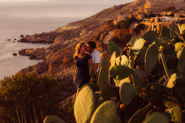 Couple kissing in the evening on the seaside