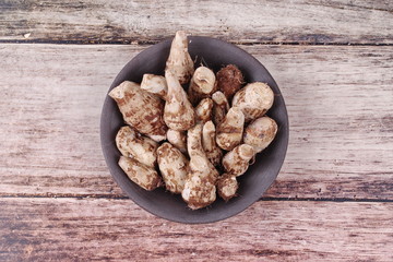 Ready served boiled taro on black dish.