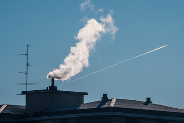 Air pollution from the smokestack of a house
