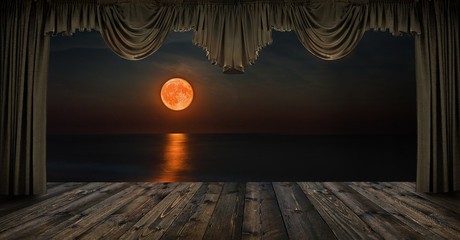 Night seascape with red moon through the window with curtains