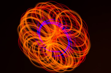Light spiral, red and blue lines on a black background