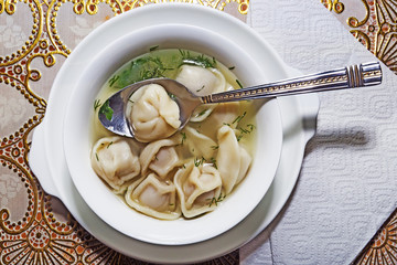 Traditional Russian Siberian pelmeni in soup