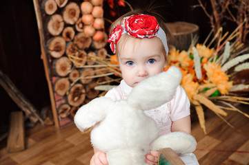 beautiful little girl with toy smiling at the camera