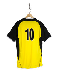 Yellow Football shirt hanging on hook and isolated on white