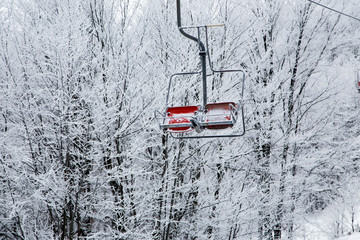 Ski lift with seats going over the mountain 