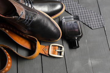 shoes and accessories for men lay on the wooden floor