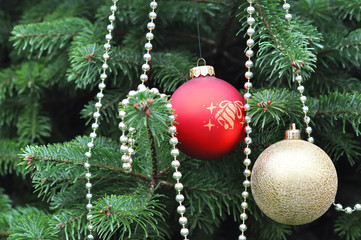 Green Christmas Tree Decorated With Red and Gold Balls Closeup