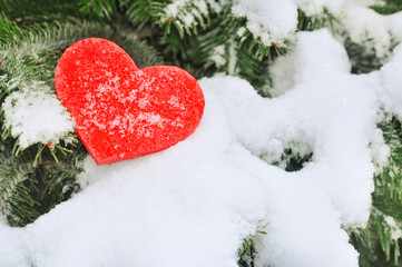 Fototapeta premium Red heart in the snow on tree