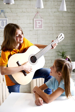 children learn to play guitar