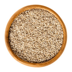 Natural white sesame seeds in wooden bowl. Unpeeled dried fruits of Sesamum, also called benne. Oilseed crops. Isolated macro food photo close up from above on white background.