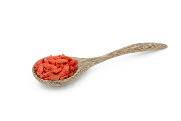 goji berries in wood spoon on white background