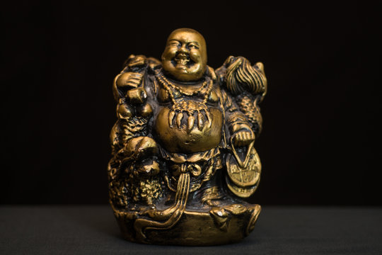 Chinese figurine Hotei, the laughing Buddha is a symbol of prosperity and money,