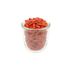 goji berries in .Glass bottles wood bowl isolated on white backg
