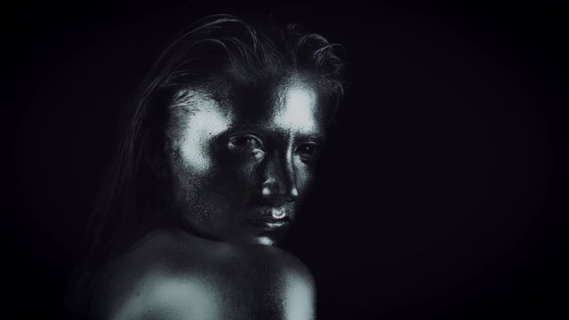4K Horror Woman with Silver Metallic Make-up Looking Evil