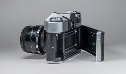 Old film camera photographed on a light background.