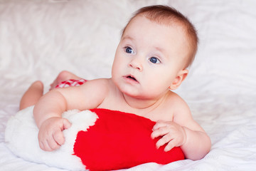 Baby lying on white soft blanket