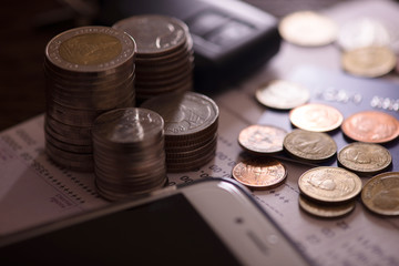 Rows of coins, account book, mobile, credit card and car key remote. Finance and banking concept.
