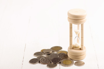 Deadline and time is money concept with hourglass. finance and banking concept.