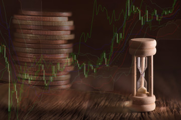 Double exposure of coin money and hourglass. finance concept.