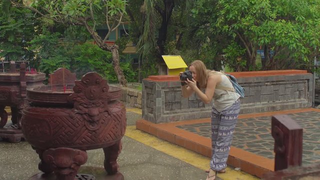 Wonam takes pictures of a buddhist prayer sticks inside temple. Incense. Asia Travel concept. Journey through Vietnam Concept.