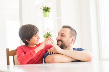 Happy father and son at modern new white home