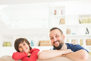 Happy father and son at modern new white home