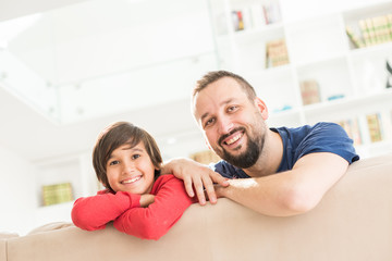 Happy father and son at modern new white home © Jasmin Merdan