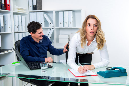 sexual harassment in office- man touch female colleague at butto