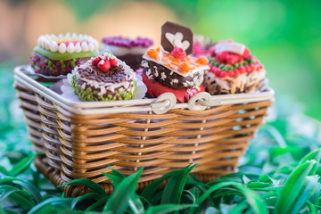 Close up small cake in basket with bokeh nature background. Vintage or retro tone.