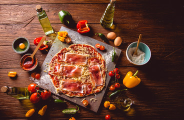 Girl is preparing homemade pizza on wooden table