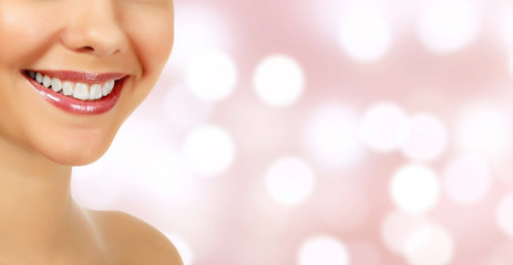Naklejka premium Woman smile closeup against an abstract background