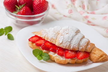 croissant with fresh strawberries, ricotta