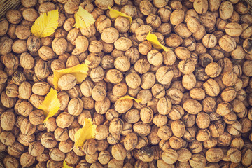 Walnuts with yellow leaves in a basket
