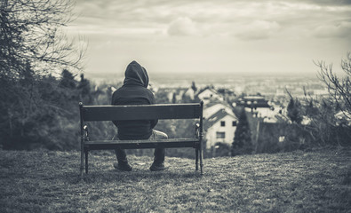 Lonely man sitting on a bench