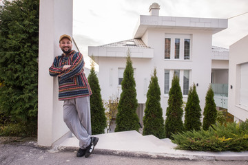 Man living his dream in front of his new modern house