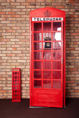 Fototapeta premium vintage phone booth near brick wall. Telephone box. Retro call box