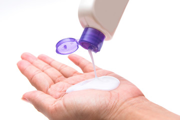 woman pouring body lotion on hand