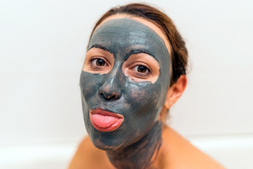 Mask of clay on the girl's funny face