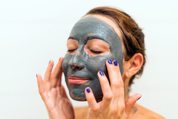 Mask of blue clay on the girl's face