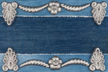 Luxury frame made of silver stucco plaster lying on denim.