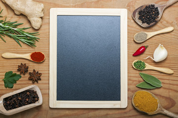 chalkboard menu on a wooden background with spices
