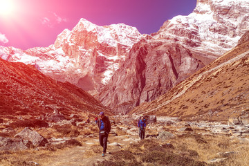 People walking on Footpath in Mountain Valley under shining Sun