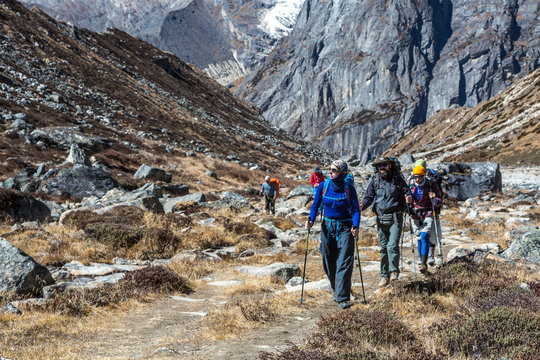 Sport Team of Mountain Climbers walking on Footpath