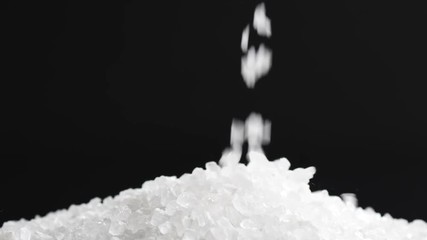coarse sea salt crystal falling on black background in slow motion, 180fps prores footage