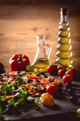 Fresh and tasty homemade pizza on wooden table with ingredients