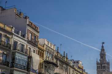 Fototapeta na wymiar Tower La Giralda with down town traditional balconies, Seville,