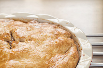 Freshly baked homemade apple pie on a wooden table