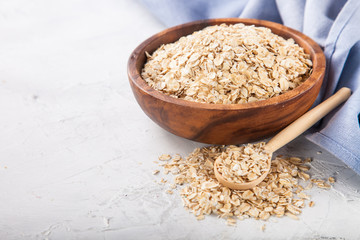 Oat flakes in a bowl on a table, selective focus, copy space