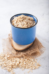 Oat flakes in a bowl on a table, selective focus, copy space